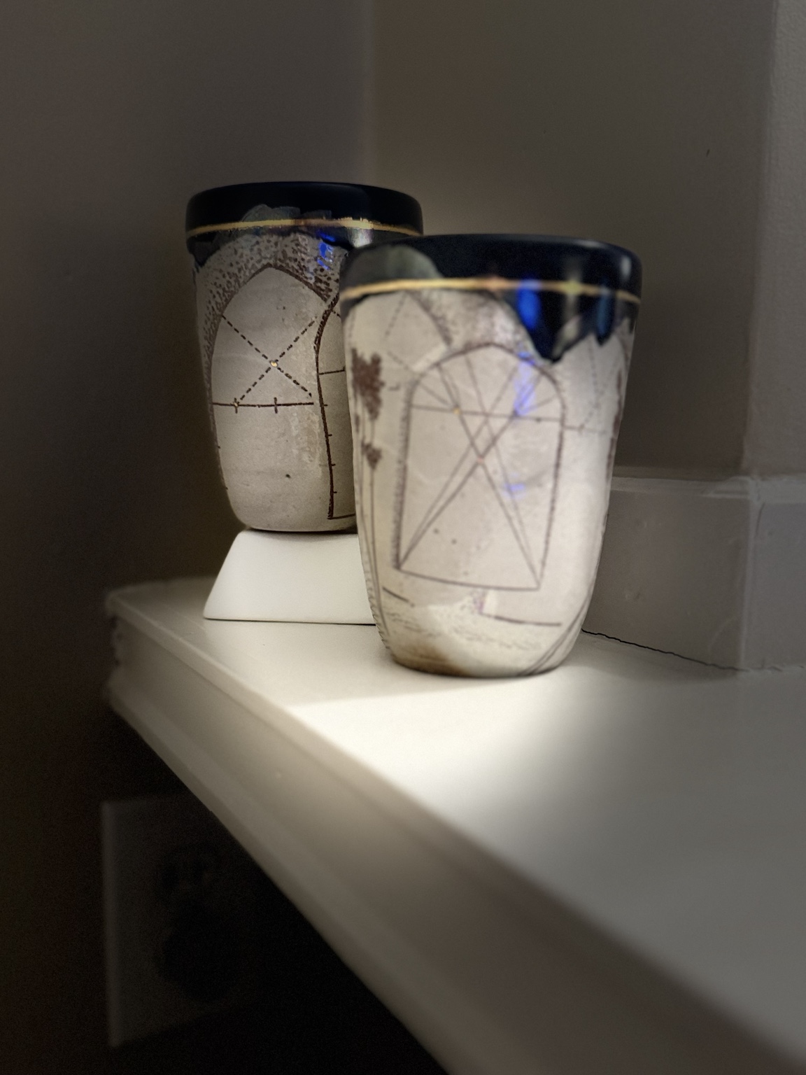 Two decorated ceramic cups