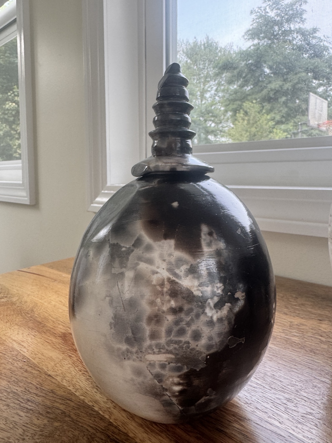 Decorative lidded ceramic vessel with raku surface